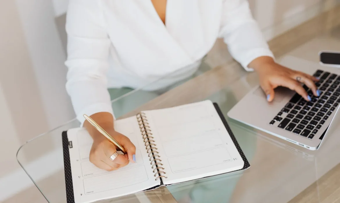 Person planning content on a laptop at a desk