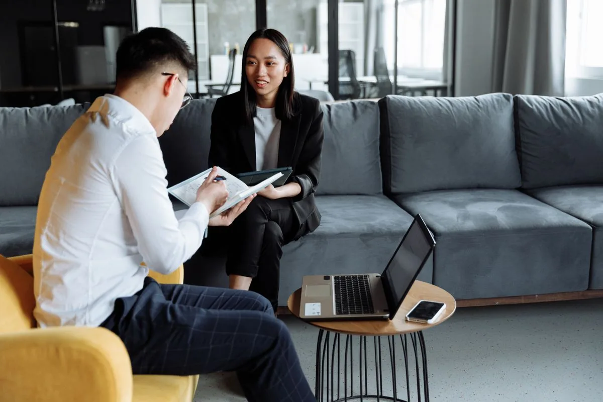 Business owner meeting a web design agency consultant to review a website proposal in a modern office