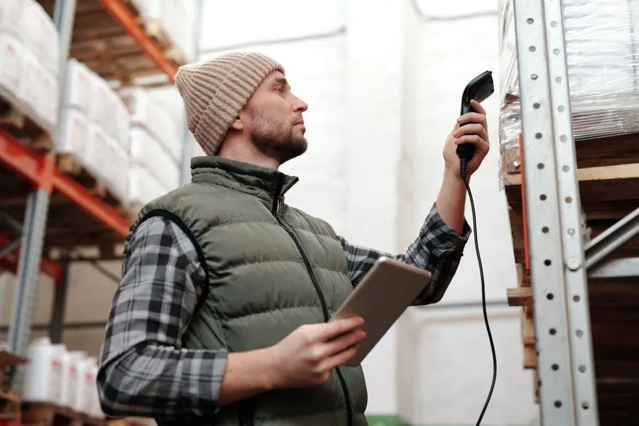 Warehouse team scanning stock into an inventory system connected to the online store