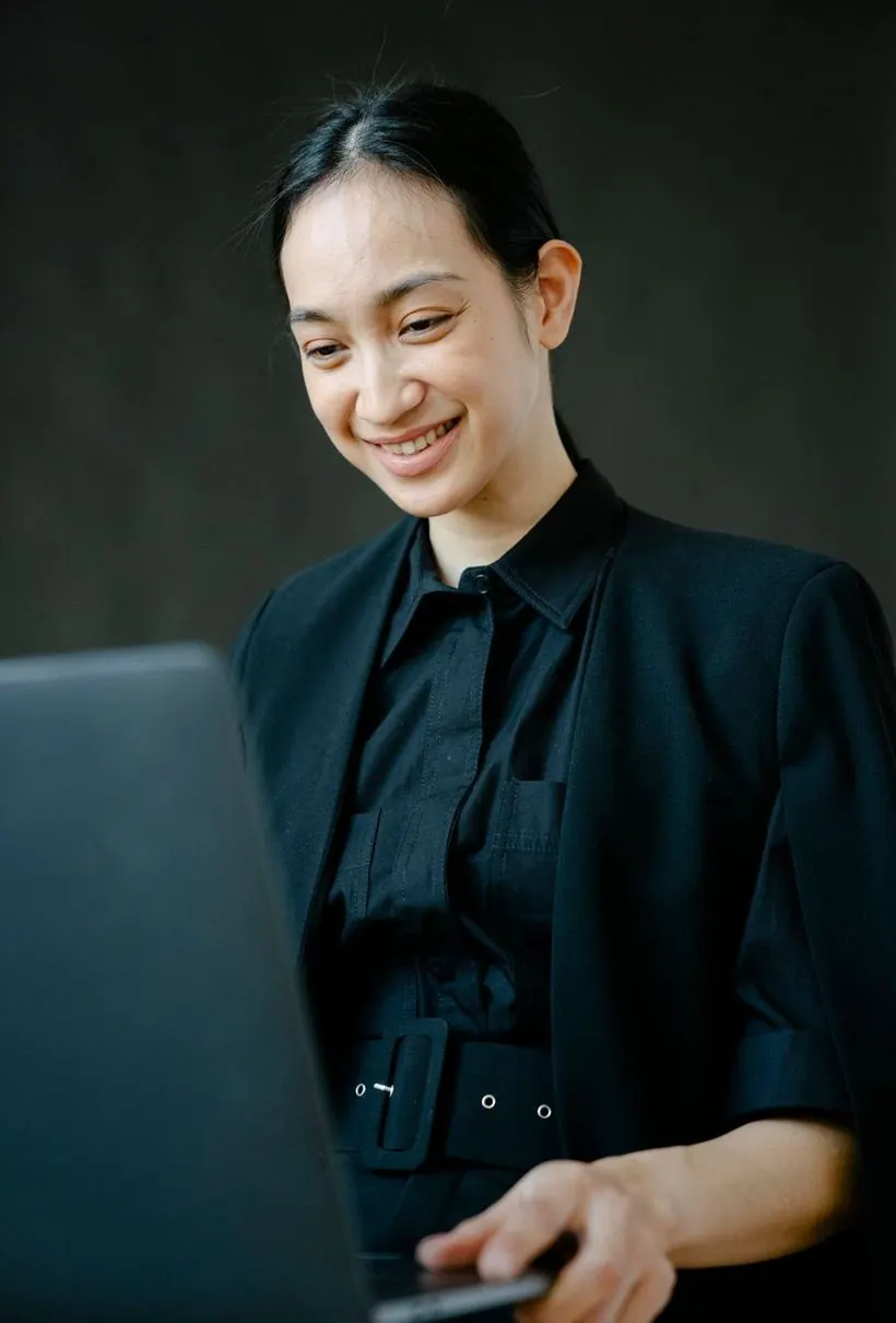 Business owner reviewing her online store on a laptop