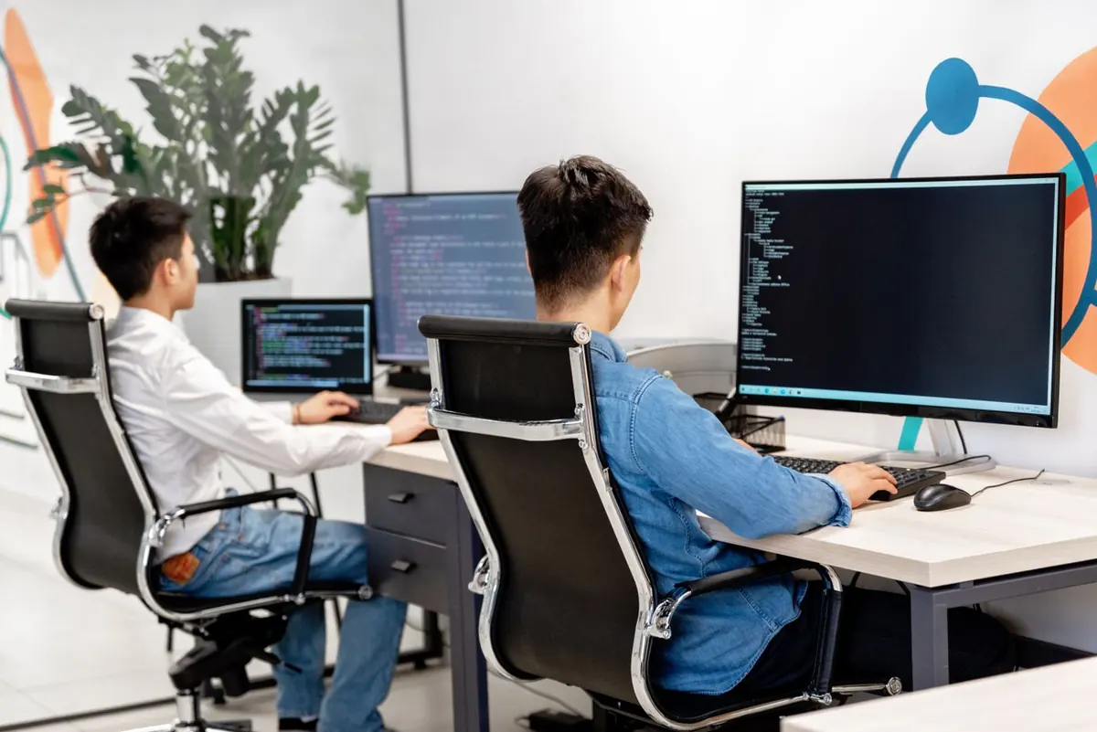 Developers building custom website functionality on dual monitors