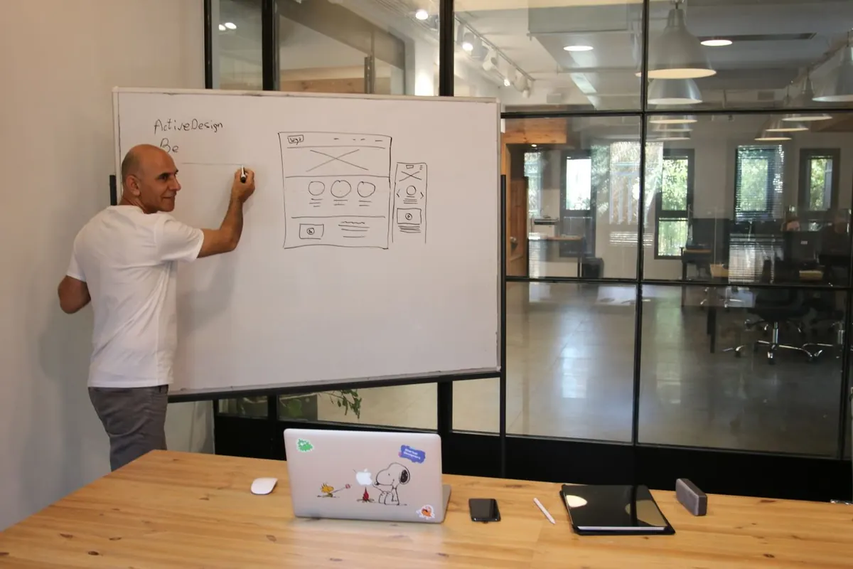 Web designer mapping page structure and user journeys on a whiteboard