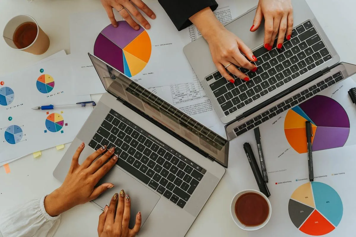 Organic traffic and conversion reports open on two laptops during an seo company singapore monthly review