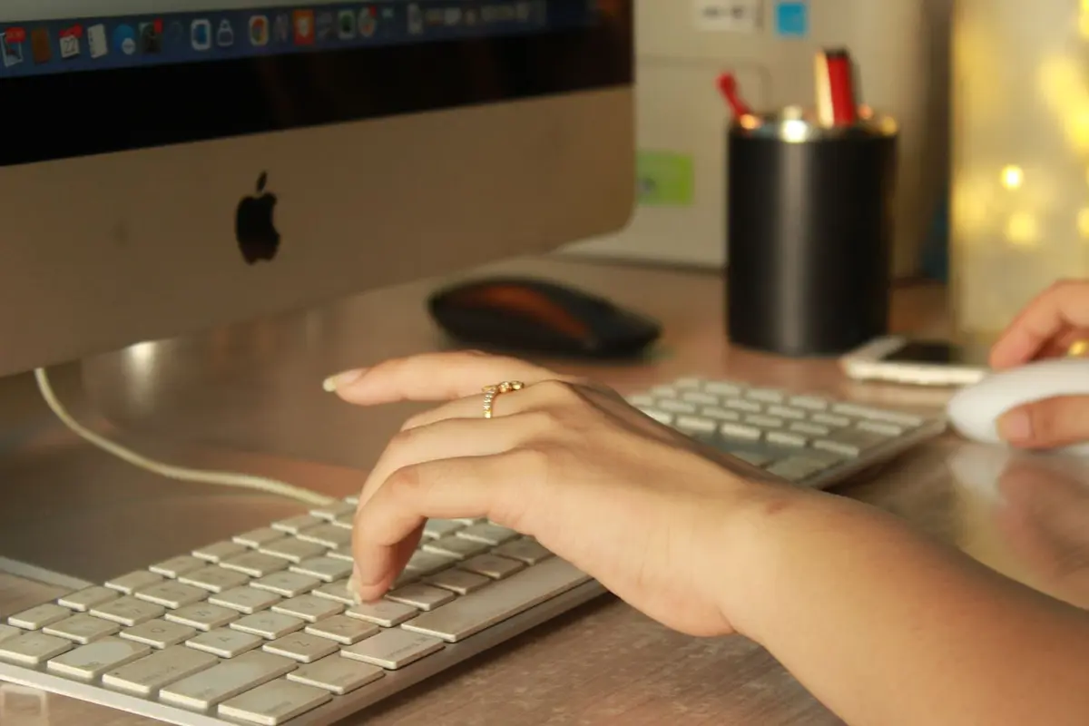 Close-up of hands typing at a keyboard during a working session