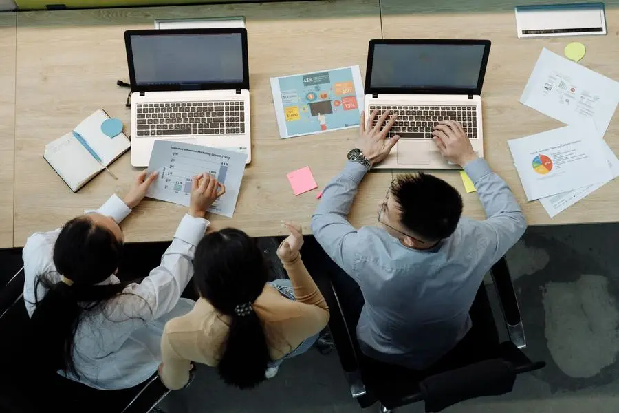 A marketing team reviewing monthly SEO reporting and ranking charts together